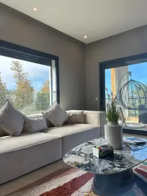 a living room with a couch and a glass table at شقة فخمه Luxury apartment in Casablanca