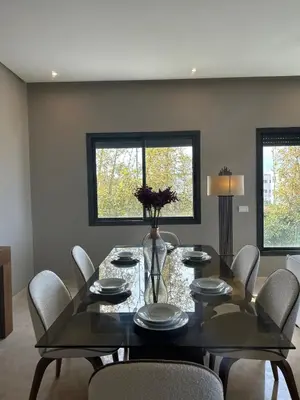 a dining room with a glass table and chairs at شقة فخمه Luxury apartment in Casablanca