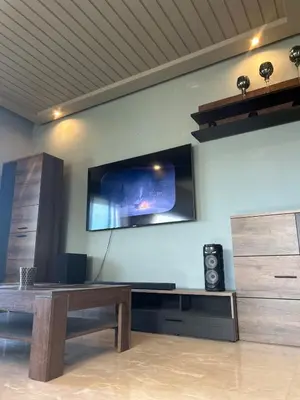 a living room with a tv on the wall at شقة فخمه Luxury apartment in Casablanca