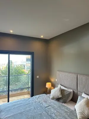 a bedroom with a bed and a large window at شقة فخمه Luxury apartment in Casablanca