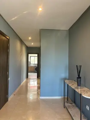 a hallway of a house with a blue wall at شقة فخمه Luxury apartment in Casablanca