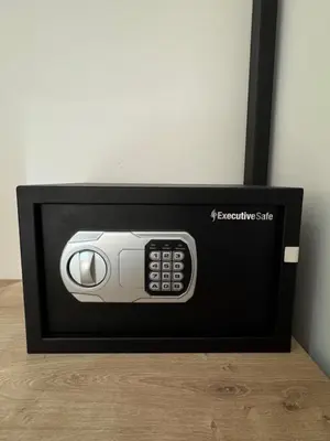 a black and white microwave with a remote control at Cosy Appartement moderne in Rabat