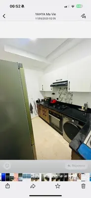 a kitchen with a refrigerator and a stove top oven at Beautiful Apartment with Seaside Pool in Mansouria