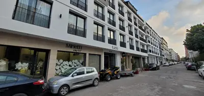 a street with cars parked in front of a building at Luxurious apartment casablanca in Casablanca
