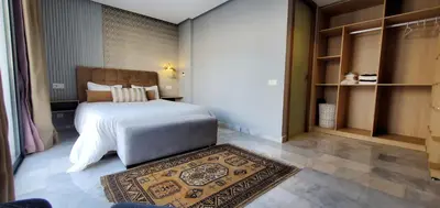 a bedroom with a large bed and a rug at Luxurious apartment casablanca in Casablanca