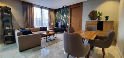 a living room with a wooden table and chairs at Luxurious apartment casablanca in Casablanca