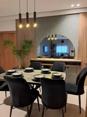 a dining room with a table and chairs and a mirror at Chahd appart centre de Rabat pour famille in Rabat