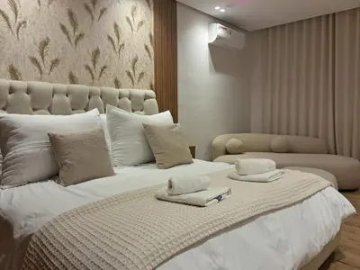 a bedroom with a large white bed with towels on it at Chahd appart centre de Rabat pour famille in Rabat