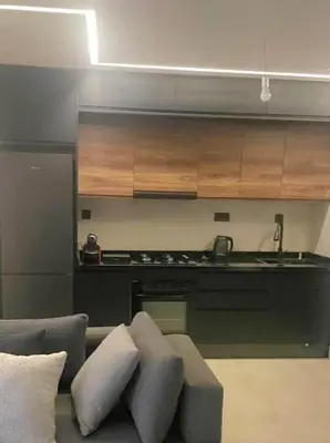a living room with a couch and a kitchen at Chahd appart centre de Rabat pour famille in Rabat