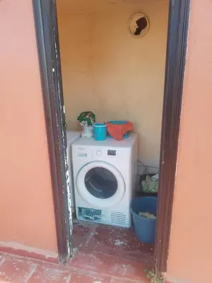 a washing machine in a corner of a room at Sense house 2 in Rabat