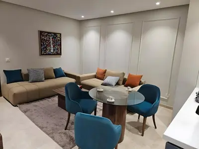 a living room with a couch and a table and chairs at Studio Seven Sky 1 - Close to CFC in Casablanca
