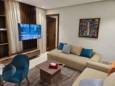 a living room with a couch and a tv at Studio Seven Sky 1 - Close to CFC in Casablanca