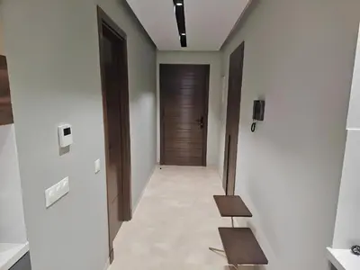a hallway with a wooden door and a wooden bench at Studio Seven Sky 1 - Close to CFC in Casablanca
