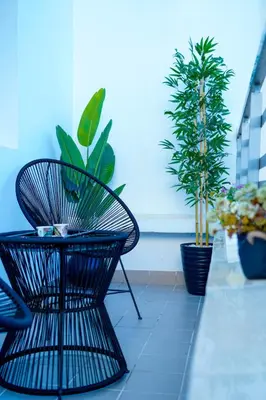 a patio with a table and chairs and potted plants at Charming 2 Bedroom Casavoyageur in Casablanca