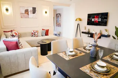 a living room with a couch and a table at Charming 2 Bedroom Casavoyageur in Casablanca