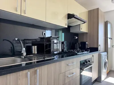 a kitchen with a sink and a stove at Appartement Miramar vue panoramique Mohammedia in Mohammedia