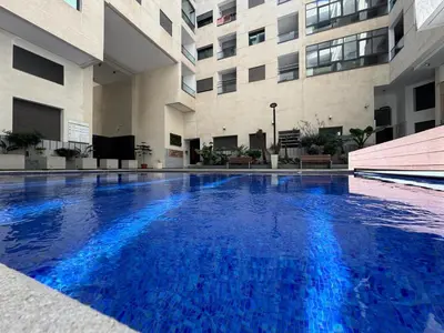 a large swimming pool in the middle of a building at Appartement Miramar vue panoramique Mohammedia in Mohammedia