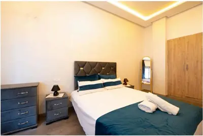 a bedroom with a large bed with two pillows at Premium Romantic 1 Bedroom & Living Room with Swimming pool & Garden view in Casablanca