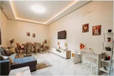 a living room with a couch and a dining room at Premium Romantic 1 Bedroom & Living Room with Swimming pool & Garden view in Casablanca