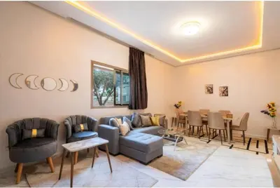a living room with a couch and a table at Premium Romantic 1 Bedroom & Living Room with Swimming pool & Garden view in Casablanca