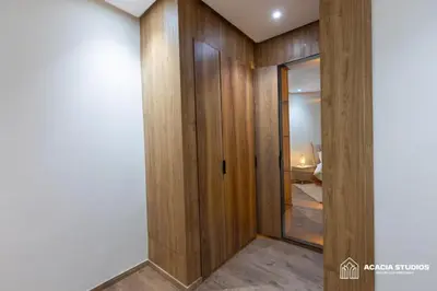 a hallway with wood paneling and a glass door at Acacia Studio 10 in Casablanca