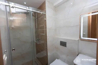 a bathroom with a glass shower with a toilet at Acacia Studio 10 in Casablanca
