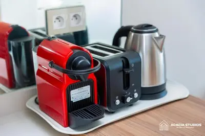 a red and black toaster sitting on a shelf at Acacia Studio 10 in Casablanca