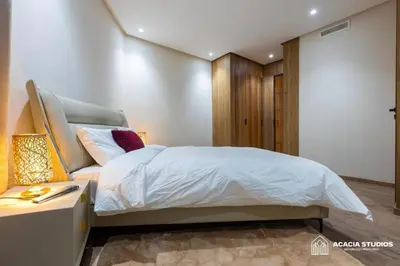 a bedroom with a bed and a desk with a lamp at Acacia Studio 10 in Casablanca