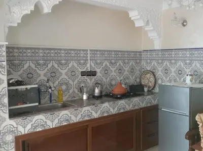 a kitchen with a sink and a refrigerator at Maison 2pc plain-pied -centre in Rabat