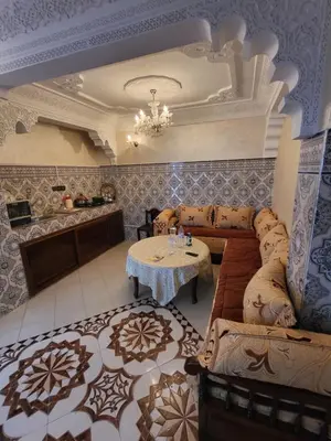 a living room with a couch and a table at Maison 2pc plain-pied -centre in Rabat