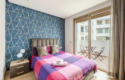 a bedroom with a large bed and a table with chairs at Sunshine sea view studio in Casablanca