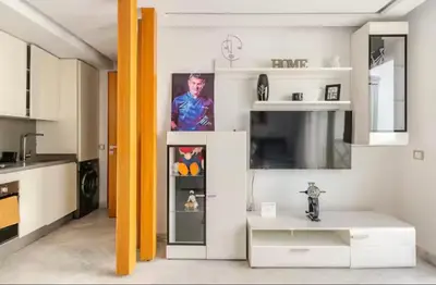 a kitchen with a table and a tv in a room at Sunshine sea view studio in Casablanca