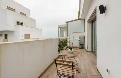 a balcony with two chairs and a wooden table at Sunshine sea view studio in Casablanca