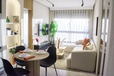 a living room with a table and a couch at Parking - Stunning View - Modern cozy and central in Casablanca