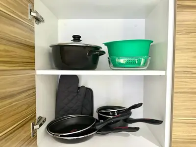 a shelf with pots and pans in a kitchen at Parking - Stunning View - Modern cozy and central in Casablanca