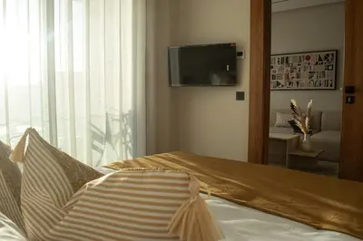 a bedroom with a bed and a flat screen tv at Parking - Stunning View - Modern cozy and central in Casablanca