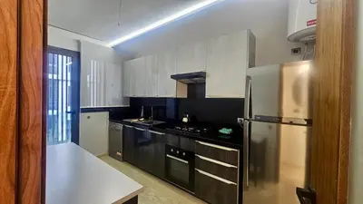 a kitchen with a stainless steel refrigerator and black cabinets at Ultimate ocean luxury in Tamaris