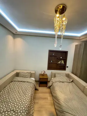 a bedroom with two beds and a chandelier at Ultimate ocean luxury in Tamaris