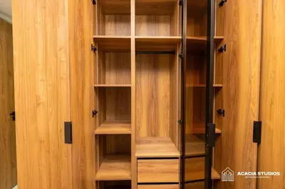 a wooden cabinet with wooden shelves in a room at Acacia Studio 02 in Casablanca