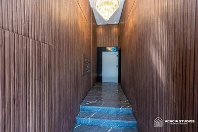 a hallway in a building with wooden walls and a door at Acacia Studio 02 in Casablanca