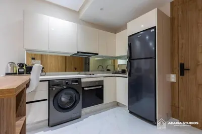 a kitchen with a black refrigerator and a dishwasher at Acacia Studio 03 in Casablanca