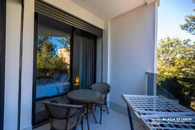 a balcony with a table and chairs and a window at Acacia Studio 04 in Casablanca