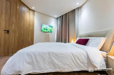 a bedroom with a large white bed and a window at Acacia Studio 05 in Casablanca