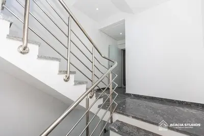 a staircase in a house with stainless steel railings at Acacia Studio 05 in Casablanca