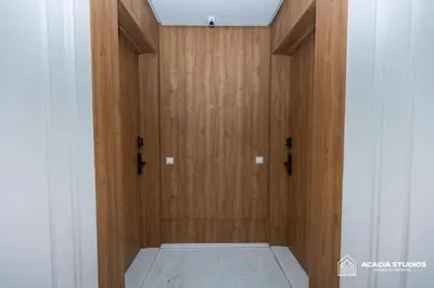 a room with a wooden door with a mattress at Acacia Studio 05 in Casablanca