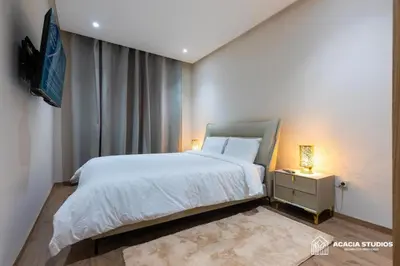 a bedroom with a bed and a tv on a wall at Acacia Studio 06 in Casablanca