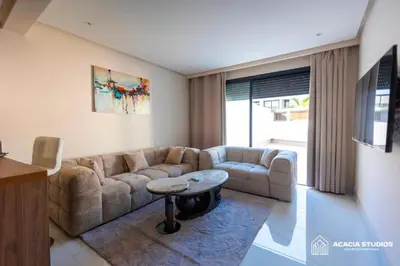 a living room with a couch and a table at Acacia Studio 06 in Casablanca