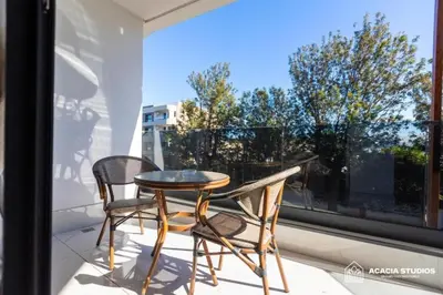 a table and two chairs on a balcony with a window at Acacia Studio 07 in Casablanca