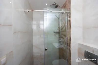 a shower with a glass door in a bathroom at Acacia Studio 09 in Casablanca