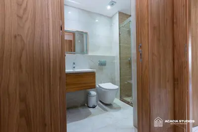 a bathroom with a toilet and a sink and a mirror at Acacia Studio 11 in Casablanca